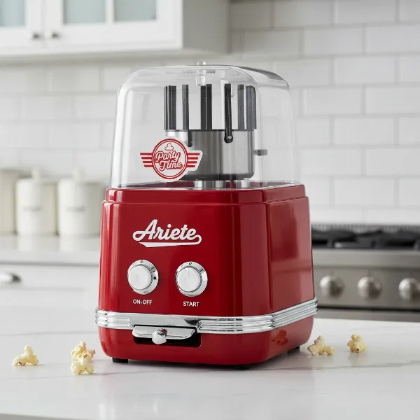 Close-up of a vibrant red Ariete Party Time Popcorn Maker with retro 1950s design on a kitchen counter.