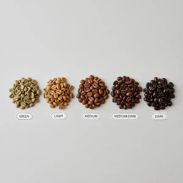 A comparison of coffee beans illustrating different roast levels from light to dark.